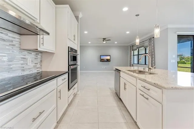 a large kitchen with stainless steel appliances lots of counter space and wooden floor