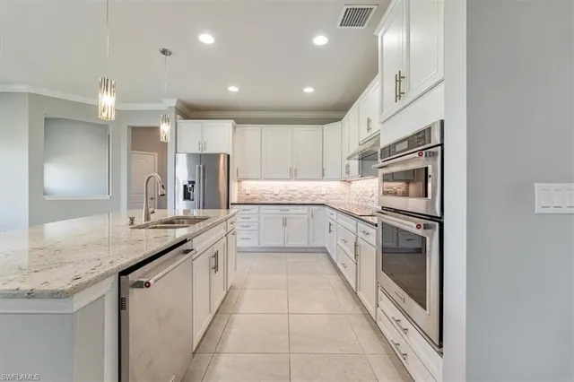 a kitchen with stainless steel appliances granite countertop a sink and cabinets