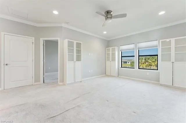 an empty room with windows and closet