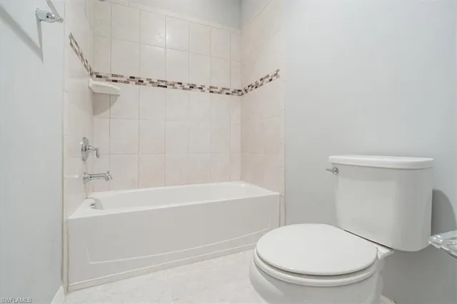a bathroom with a toilet and a bathtub
