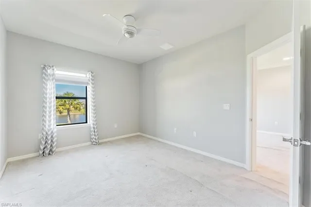 an empty room with a window and fireplace