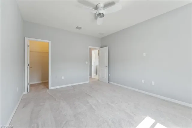 a view of an empty room with a chandelier