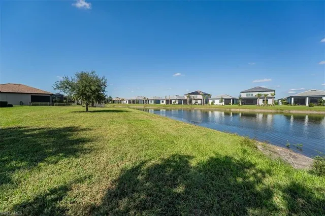 a view of a lake with houses in the back