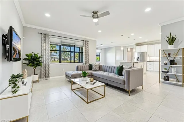 a living room with furniture a chandelier and a flat screen tv