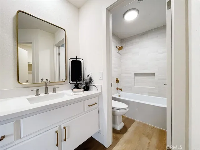 a bathroom with a double vanity sink toilet and shower