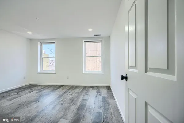 a view of a room with wooden floor
