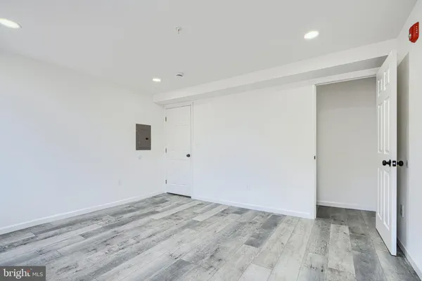 a view of an empty room with wooden floor