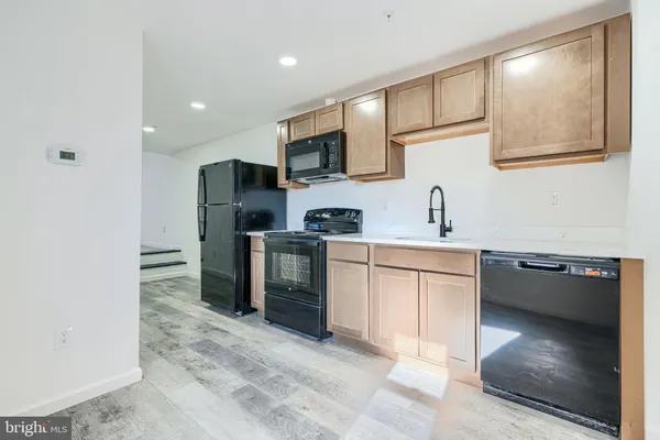 a kitchen with a sink cabinets and stainless steel appliances