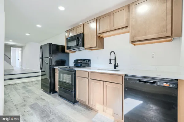 a kitchen with stainless steel appliances granite countertop a stove and a microwave