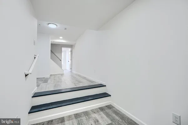 wooden floor with white walls