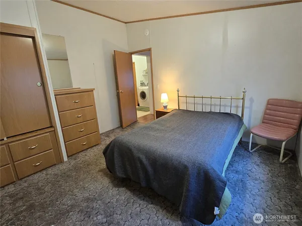 a bedroom with a bed and a dresser