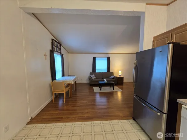 a view of kitchen with furniture and refrigerator