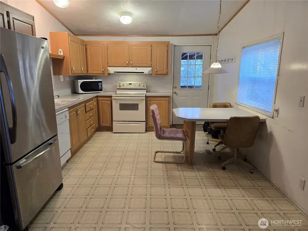 a kitchen with a sink a counter and stainless steel appliances