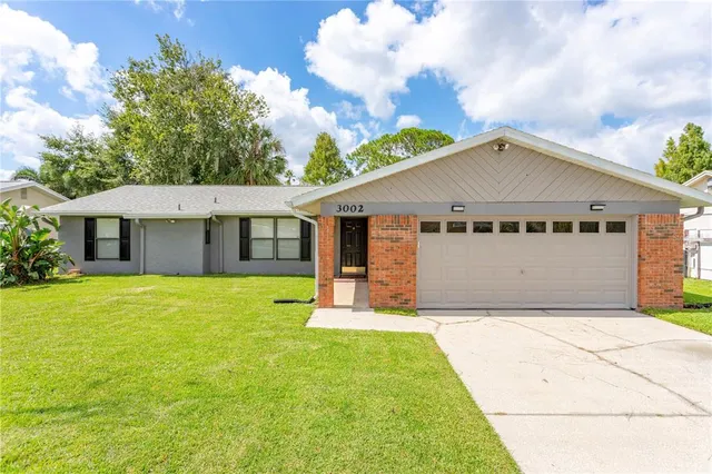 a front view of a house with yard and garage