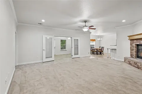 a living room with furniture a fireplace and a kitchen view