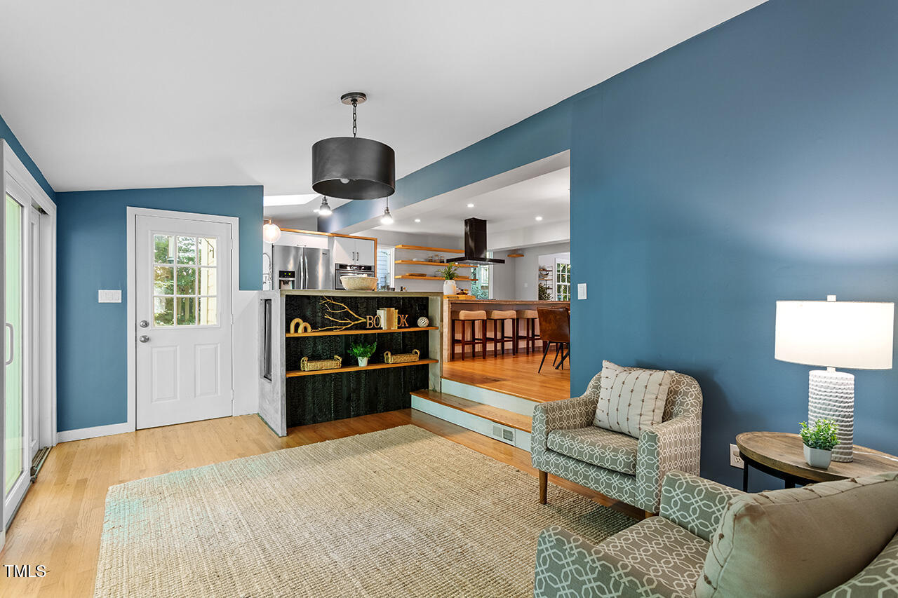 1607 Lorraine Road Raleigh, NC 27607 - Photo 20 of 37 The den is located of the kitchen and dining area and has access to the deck.