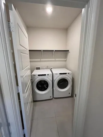 a large kitchen with a center island and stainless steel appliances