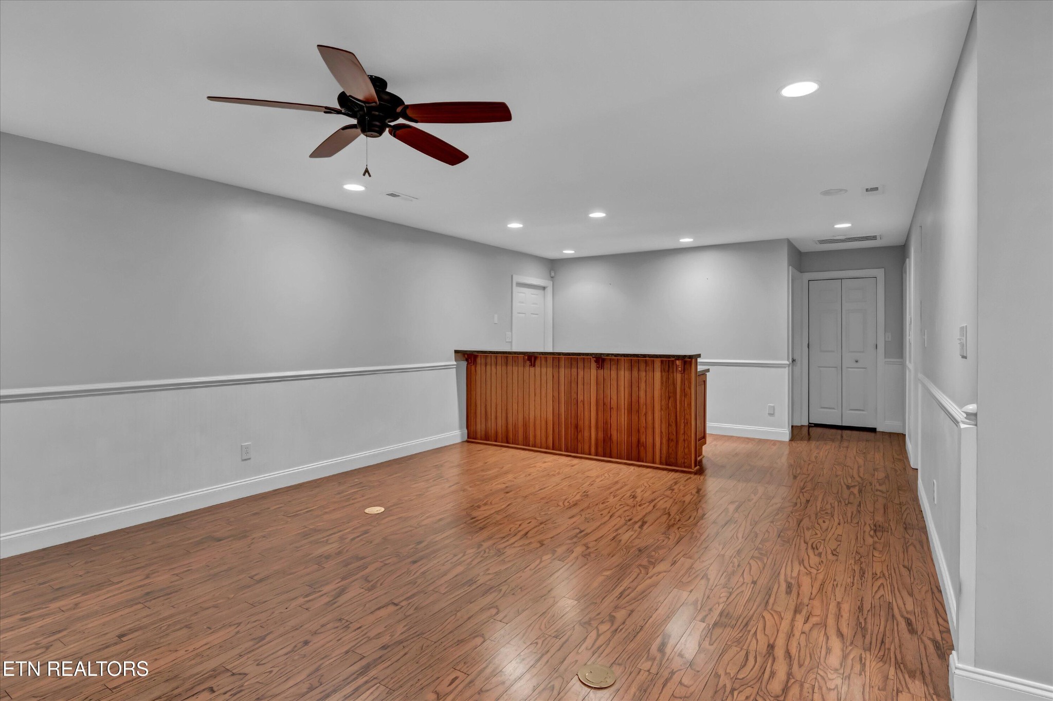 140 Ootsima Way Loudon, TN 37774 - Photo 20 of 31 an empty room with wooden floor a ceiling fan and windows