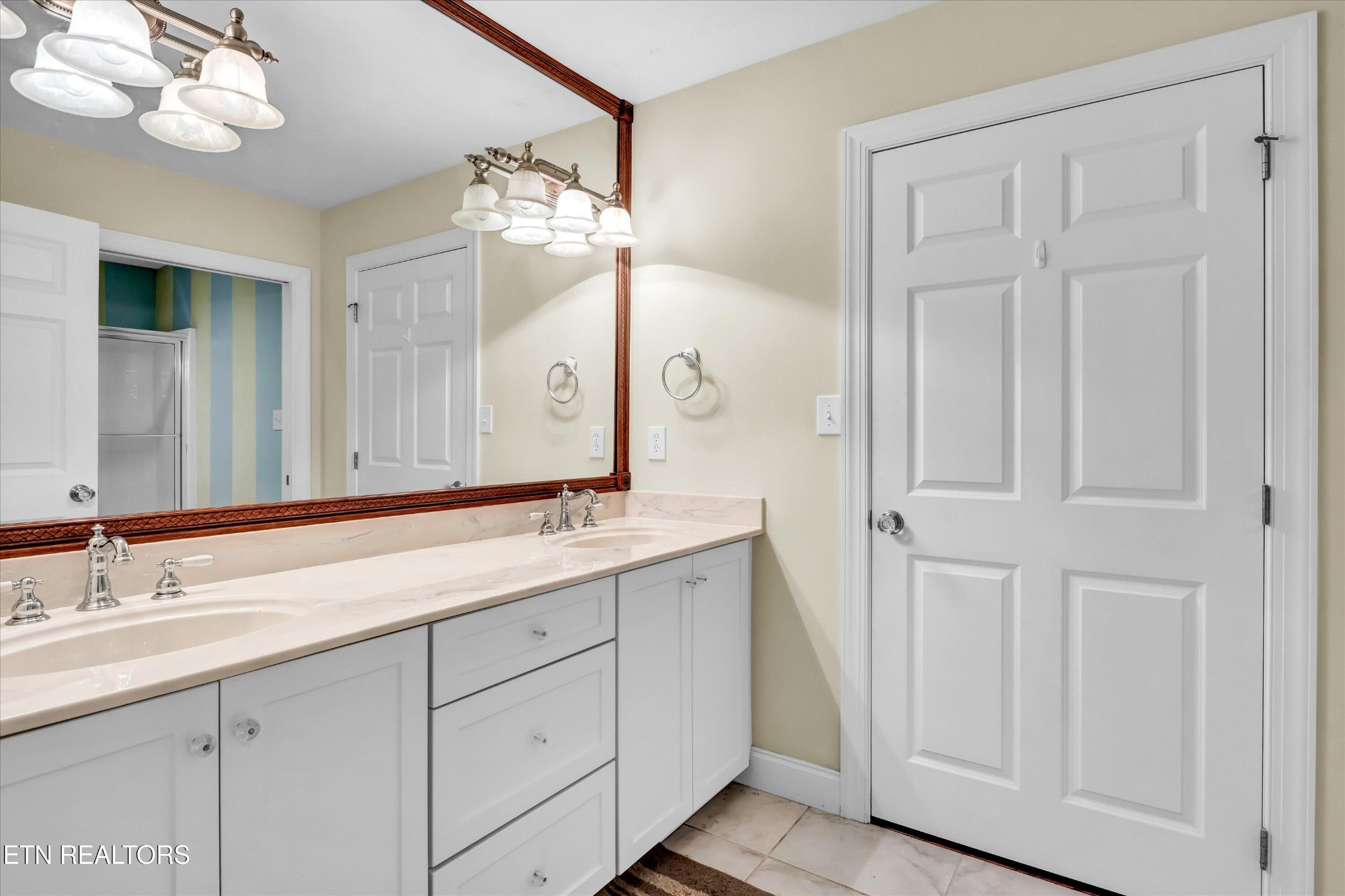 140 Ootsima Way Loudon, TN 37774 - Photo 24 of 31 a bathroom with a double vanity sink and a mirror