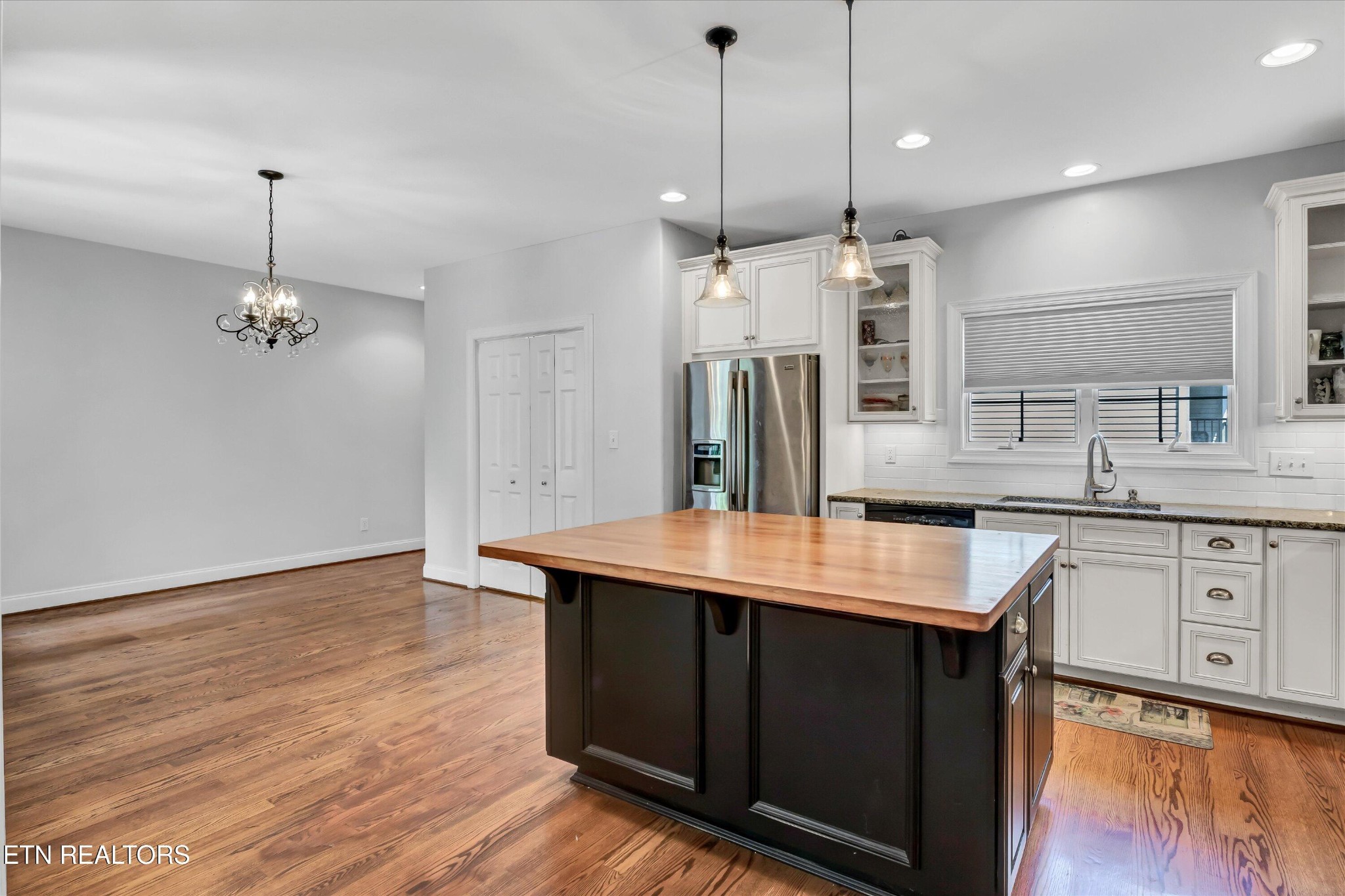 140 Ootsima Way Loudon, TN 37774 - Photo 6 of 31 a large kitchen with stainless steel appliances kitchen island a wooden floor and a sink