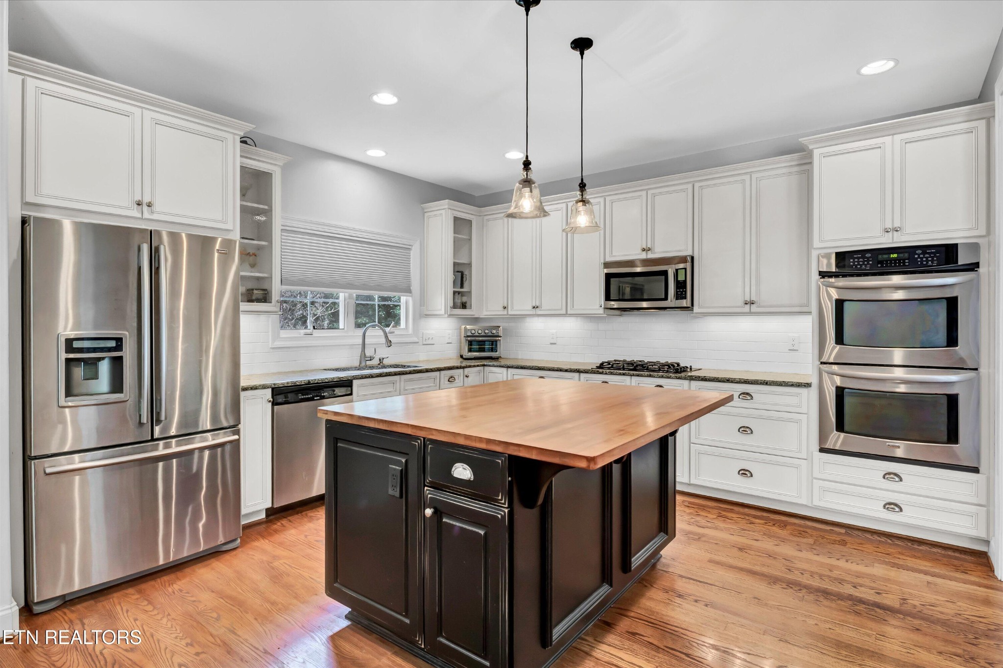 140 Ootsima Way Loudon, TN 37774 - Photo 7 of 31 a kitchen with stainless steel appliances granite countertop a stove a sink and a refrigerator