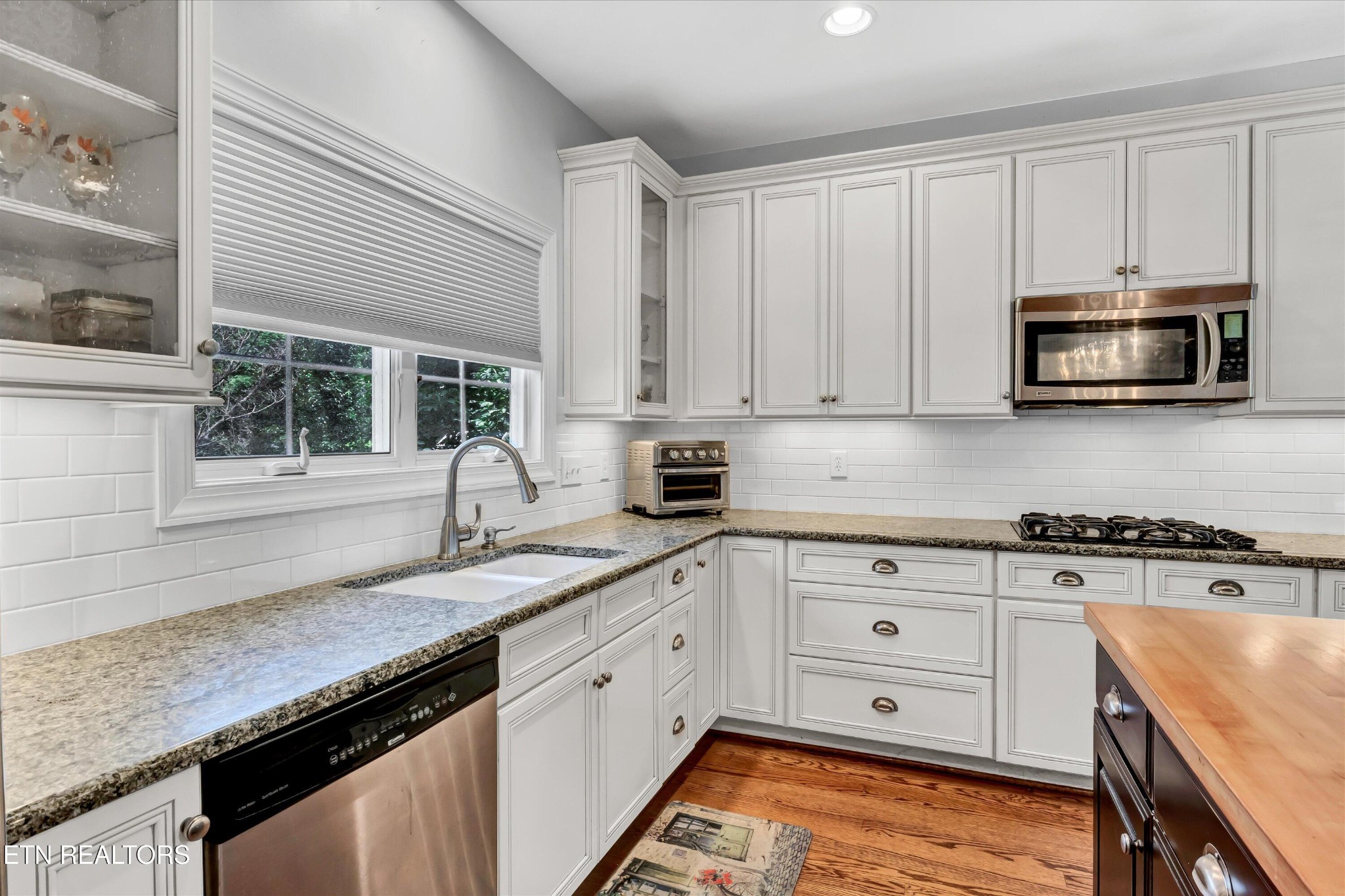 140 Ootsima Way Loudon, TN 37774 - Photo 8 of 31 a kitchen with granite countertop white cabinets and stainless steel appliances