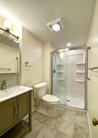 a bathroom with a sink toilet and shower
