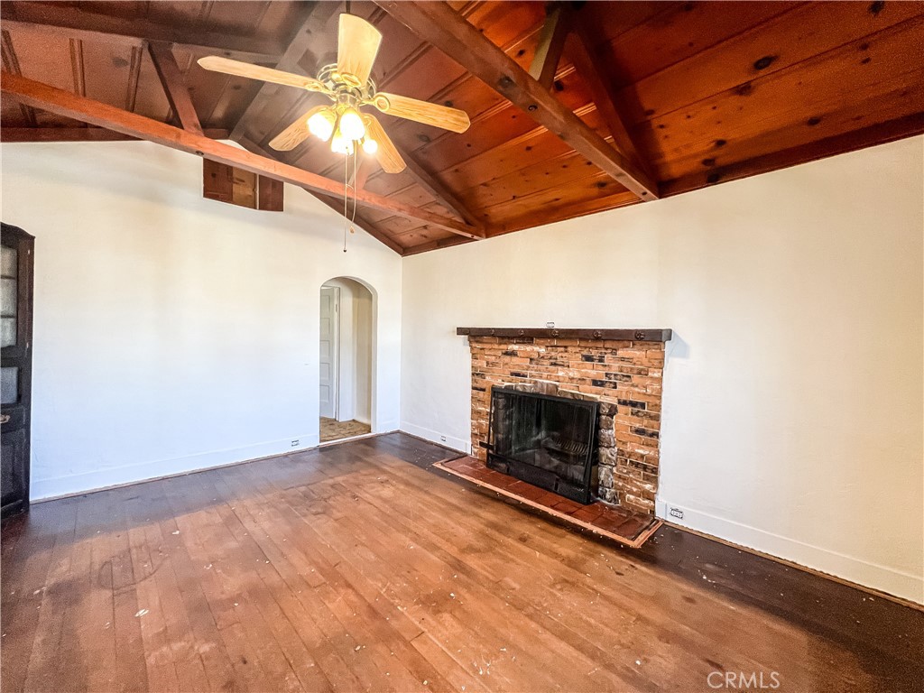 506 Desnok Street Needles, CA 92363 - Photo 12 of 70 a view of empty room with wooden floor and a fireplace