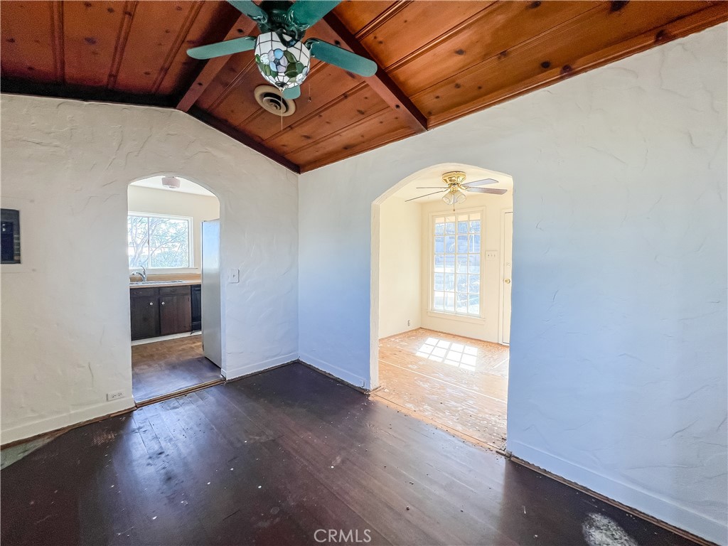 506 Desnok Street Needles, CA 92363 - Photo 17 of 70 an empty room with wooden floor cabinet and windows