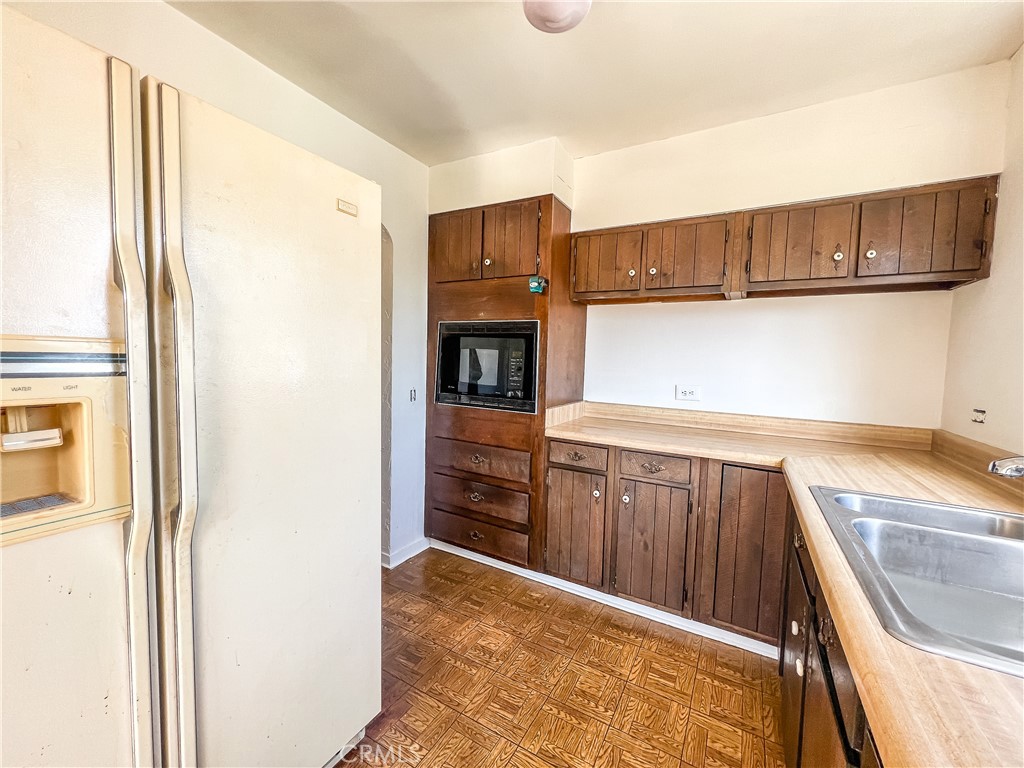 506 Desnok Street Needles, CA 92363 - Photo 31 of 70 a kitchen with stainless steel appliances granite countertop a refrigerator and a sink