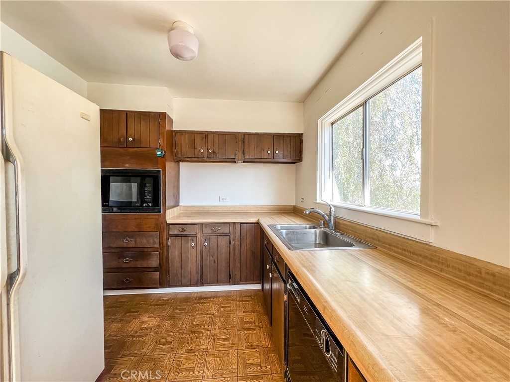 506 Desnok Street Needles, CA 92363 - Photo 32 of 70 a kitchen with granite countertop a sink and a stove top oven
