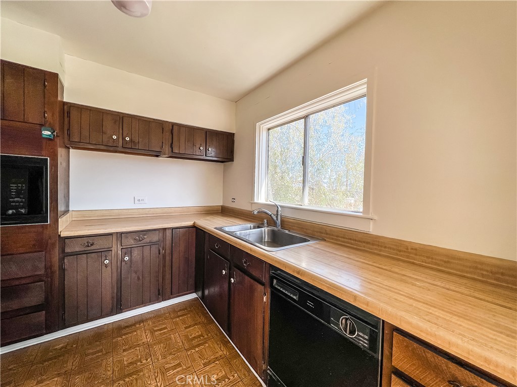 506 Desnok Street Needles, CA 92363 - Photo 35 of 70 a kitchen with a sink stove and cabinets