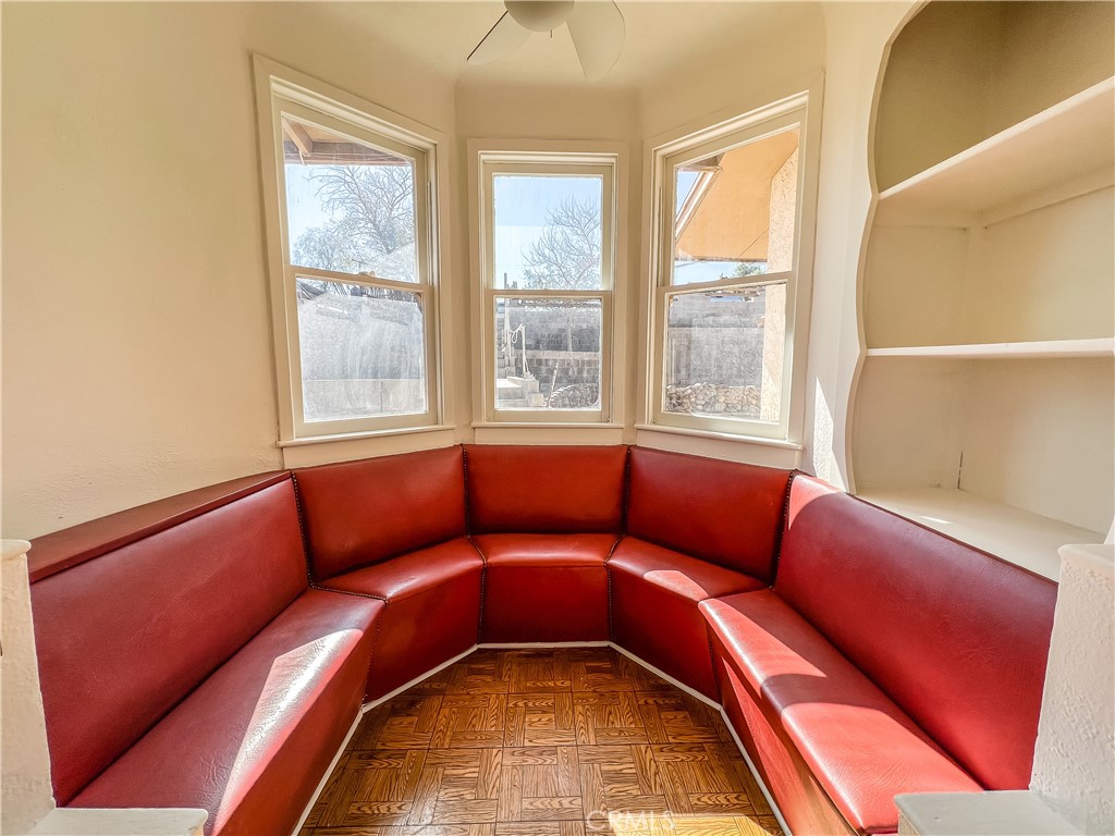 506 Desnok Street Needles, CA 92363 - Photo 40 of 70 a blue couch sitting in a blue room next to a window