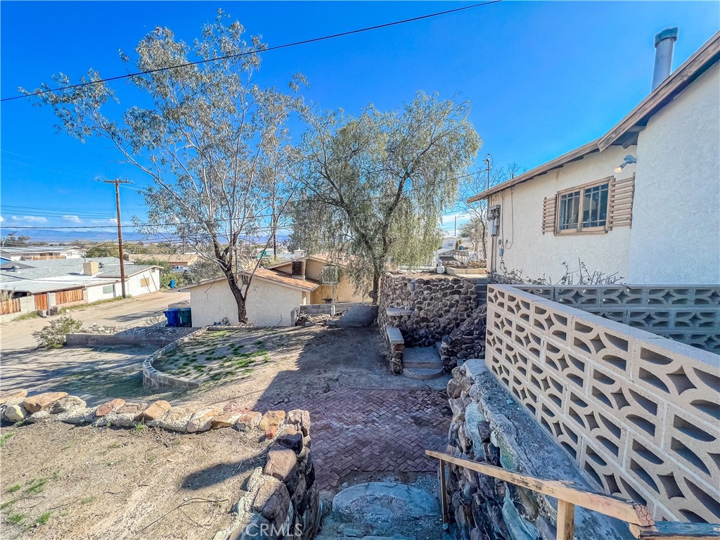 506 Desnok Street Needles, CA 92363 - Photo 4 of 70 a backyard of a house with barbeque oven and outdoor seating