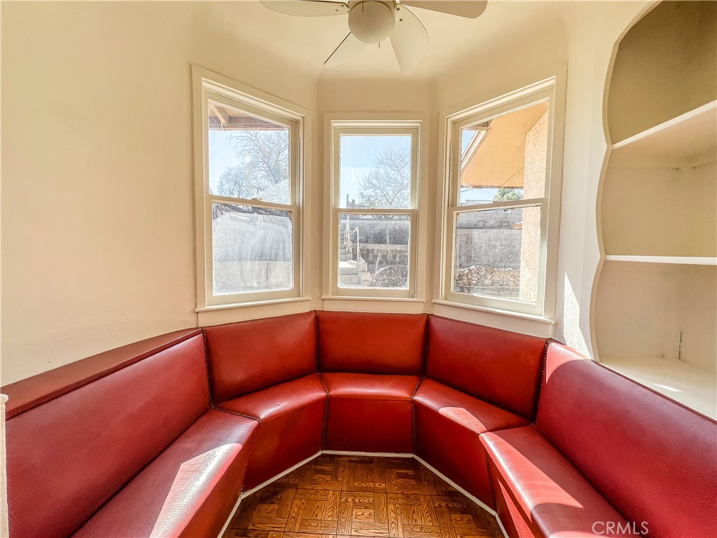 506 Desnok Street Needles, CA 92363 - Photo 41 of 70 a blue couch sitting in a blue room with a large window