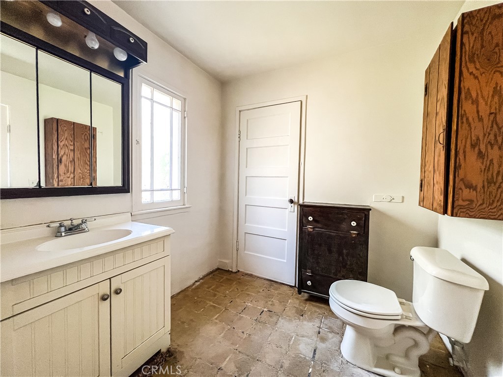 506 Desnok Street Needles, CA 92363 - Photo 44 of 70 a bathroom with a granite countertop toilet sink and mirror