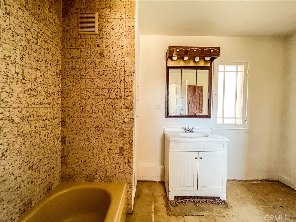 506 Desnok Street Needles, CA 92363 - Photo 46 of 70 a bathroom with a sink a bathtub and a shower