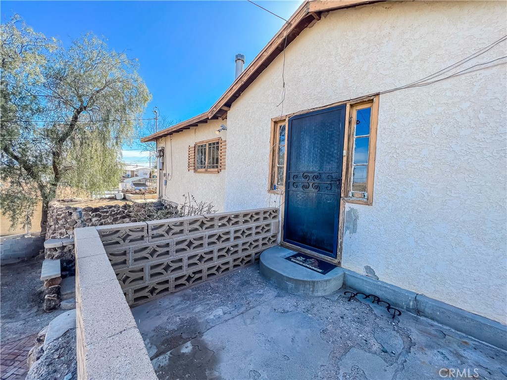 506 Desnok Street Needles, CA 92363 - Photo 7 of 70 a front view of a house with a yard