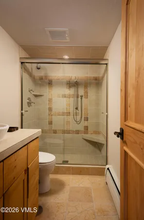 a bathroom with a shower and a sink