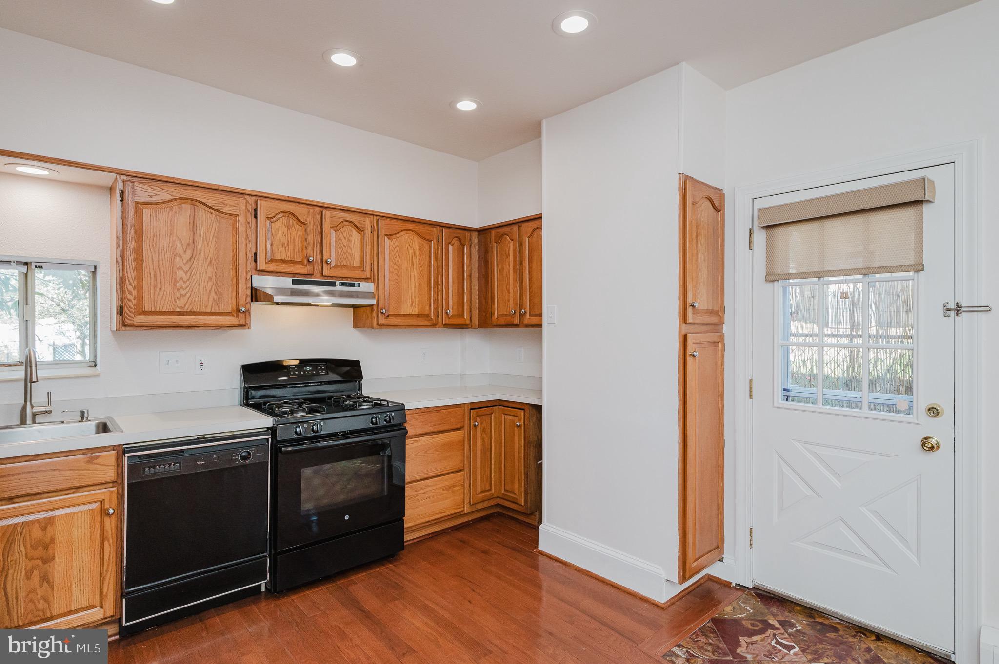 3518 Poole Street Baltimore, MD 21211 - Photo 15 of 59 a kitchen with stainless steel appliances granite countertop a stove and a refrigerator