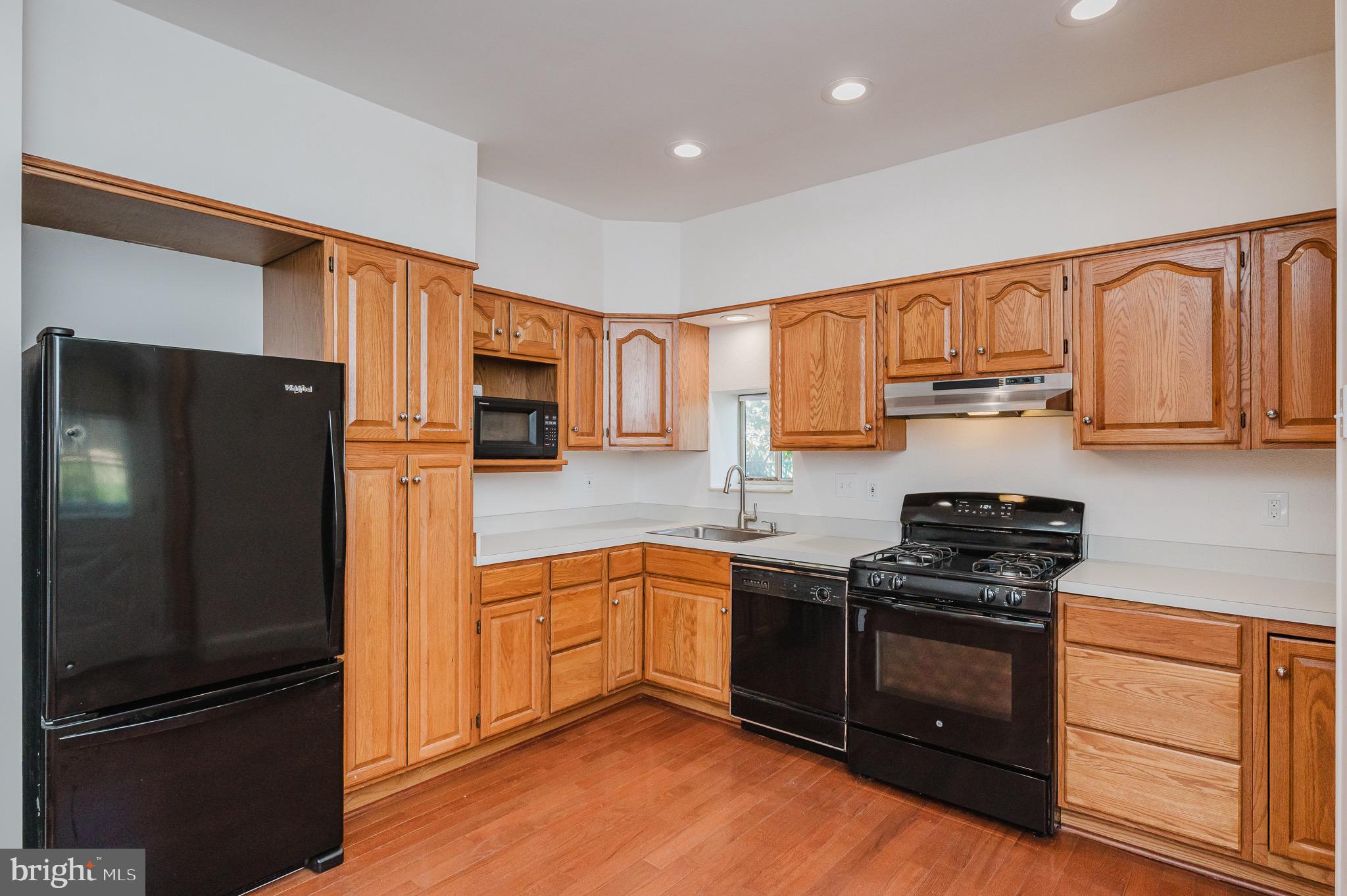 3518 Poole Street Baltimore, MD 21211 - Photo 17 of 59 a kitchen with granite countertop stainless steel appliances and wooden cabinets