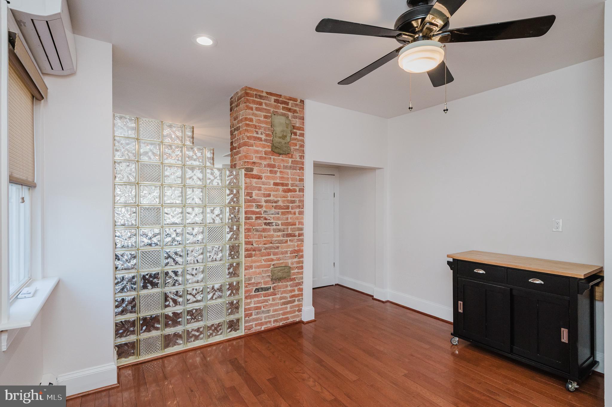 3518 Poole Street Baltimore, MD 21211 - Photo 19 of 59 wooden floor in an empty room with a window