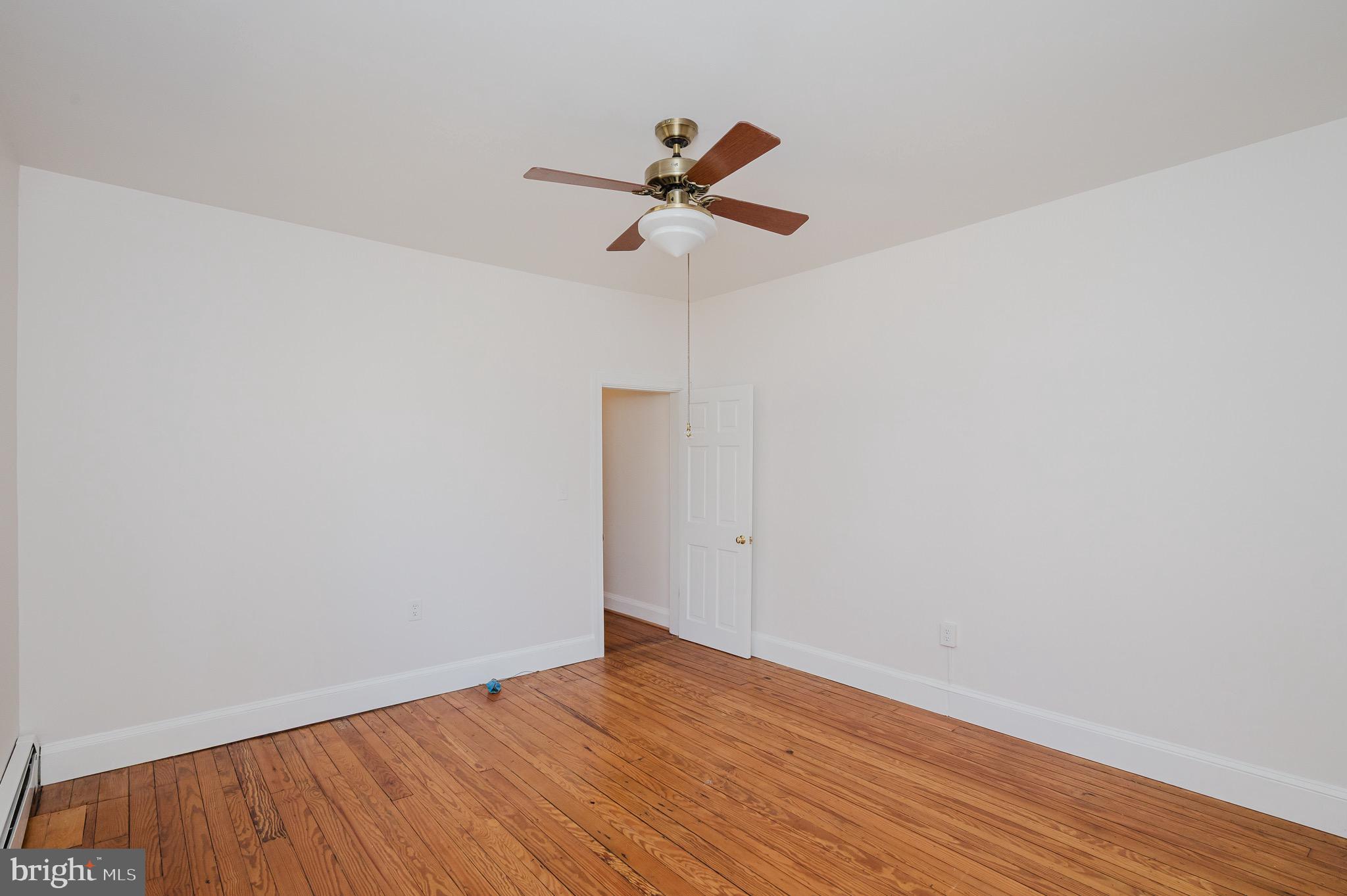 3518 Poole Street Baltimore, MD 21211 - Photo 24 of 59 a view of empty room with wooden floor
