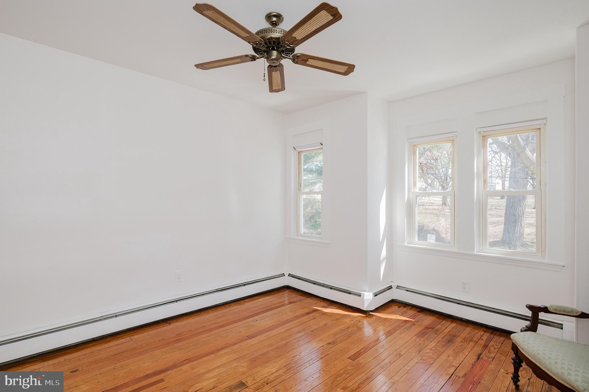 3518 Poole Street Baltimore, MD 21211 - Photo 29 of 59 wooden floor in an empty room with a window