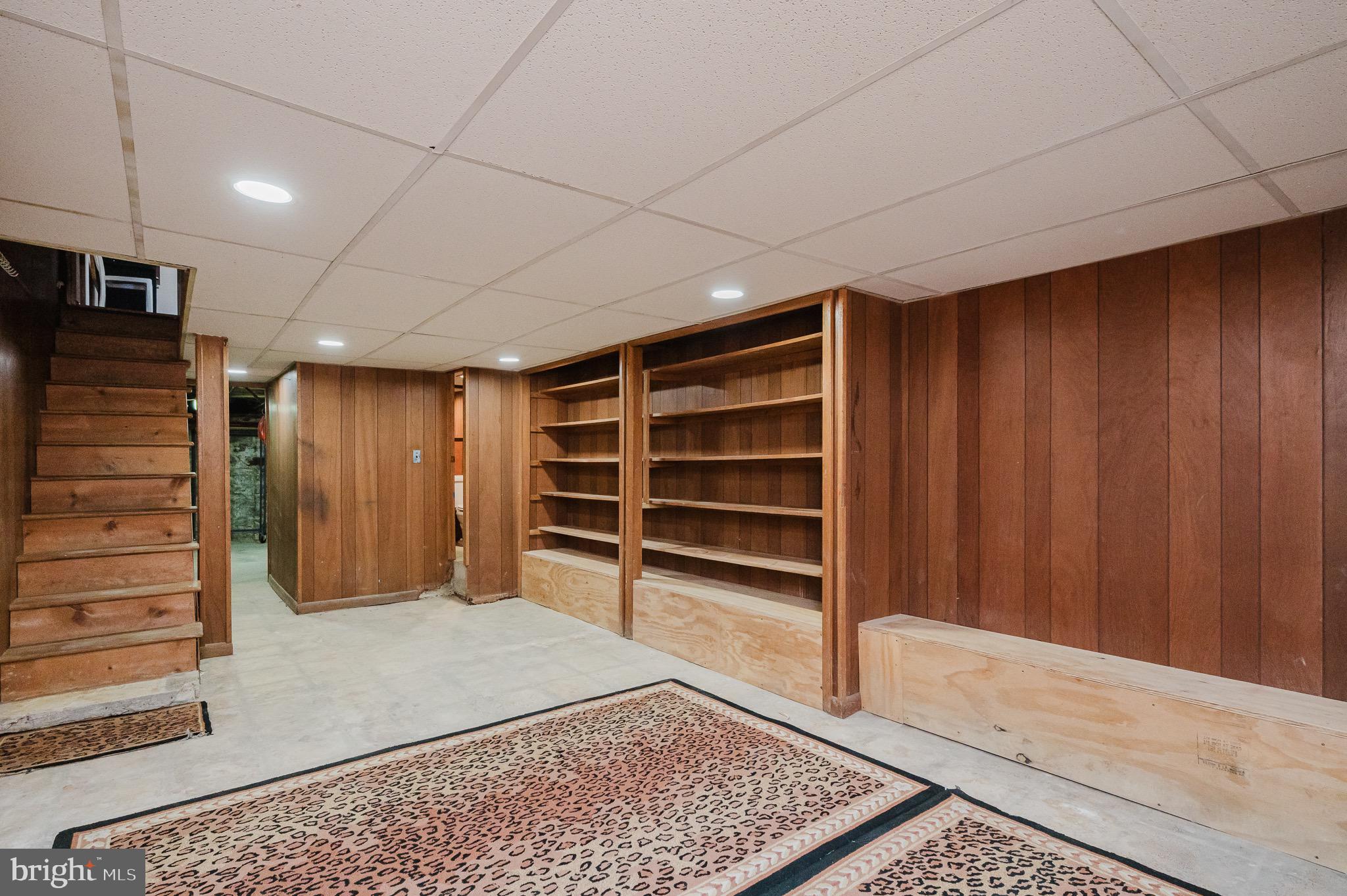 3518 Poole Street Baltimore, MD 21211 - Photo 39 of 59 a view of an empty room with wooden walls and stairs