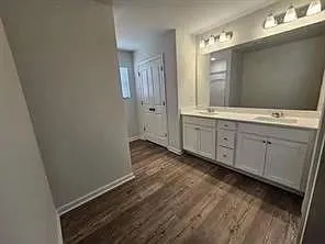 a spacious bathroom with a sink and a mirror