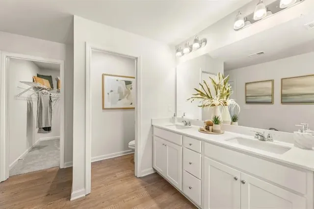 a bathroom with a double vanity sink mirror and