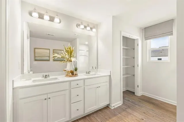 a bathroom with a double vanity sink and mirror