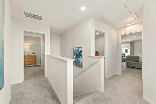 a view of a hallway view with three rooms