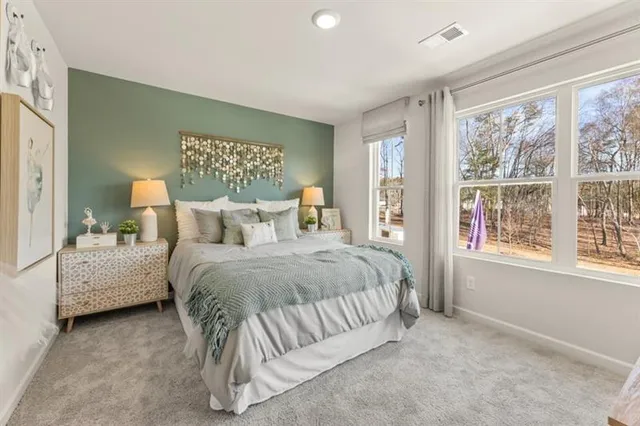 a spacious bedroom with a bed and a large window